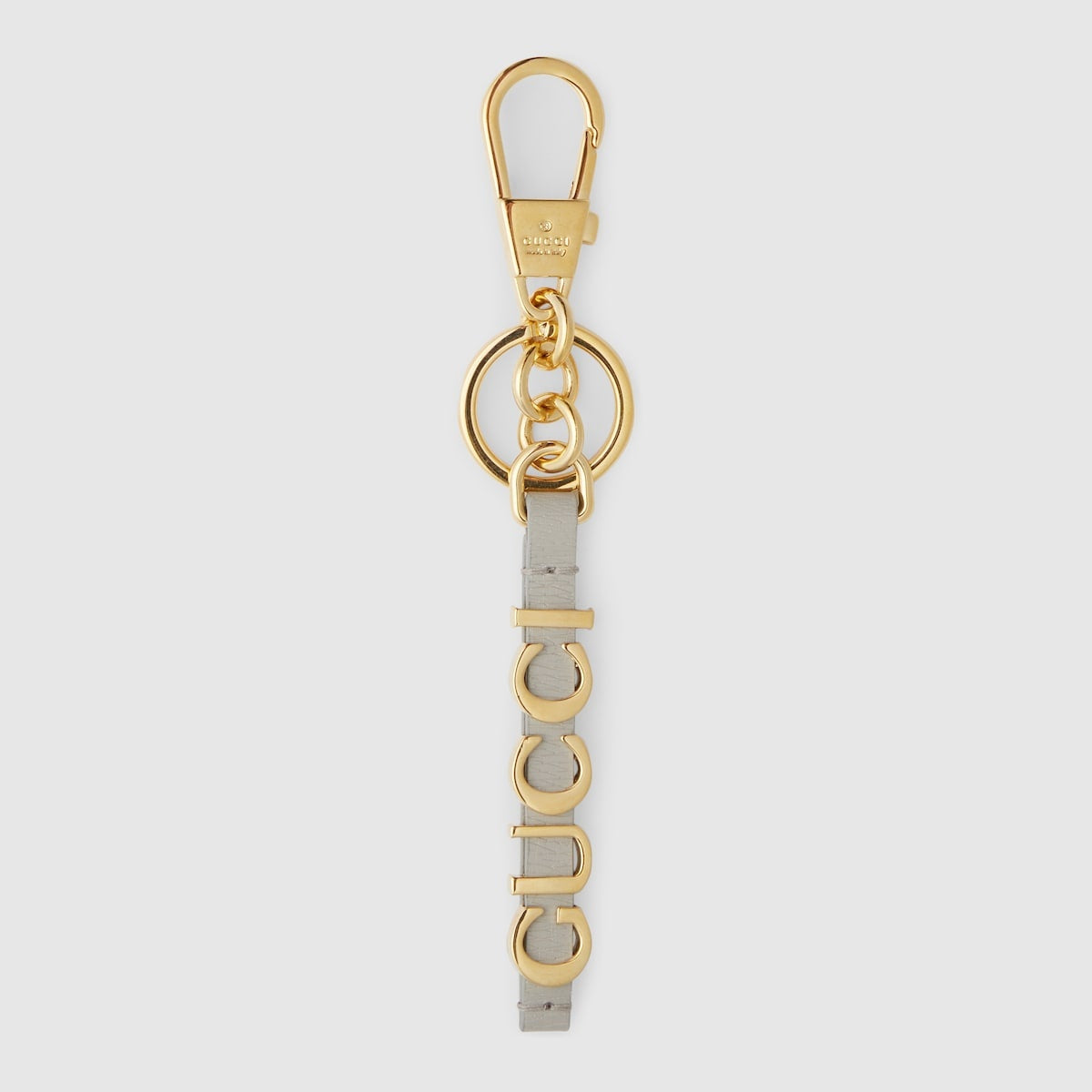 New Gucci Keychain with Gucci script in gold-toned brass